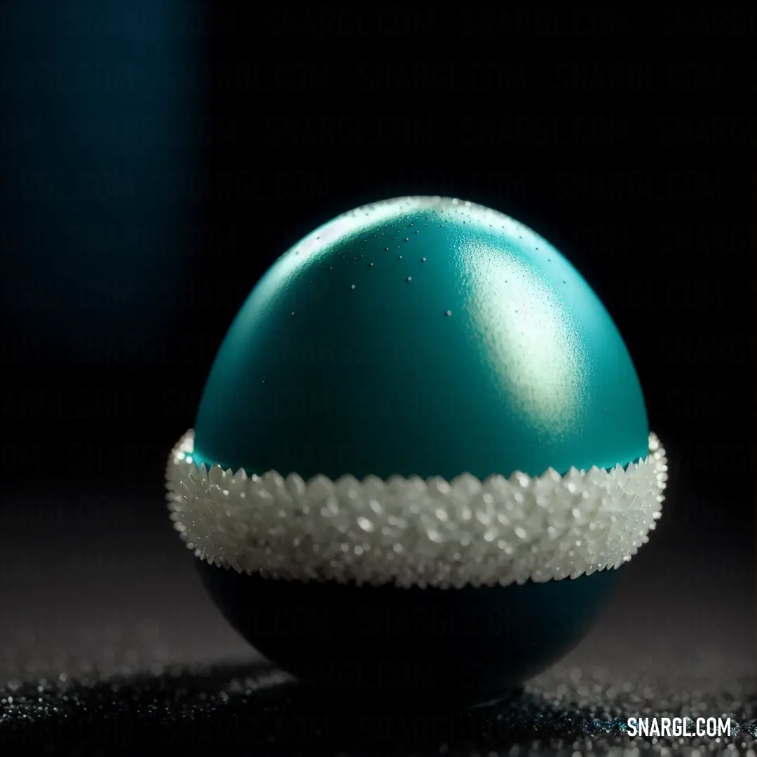 PANTONE 3165 color. Blue and white egg with a white stripe on it's side on a black background