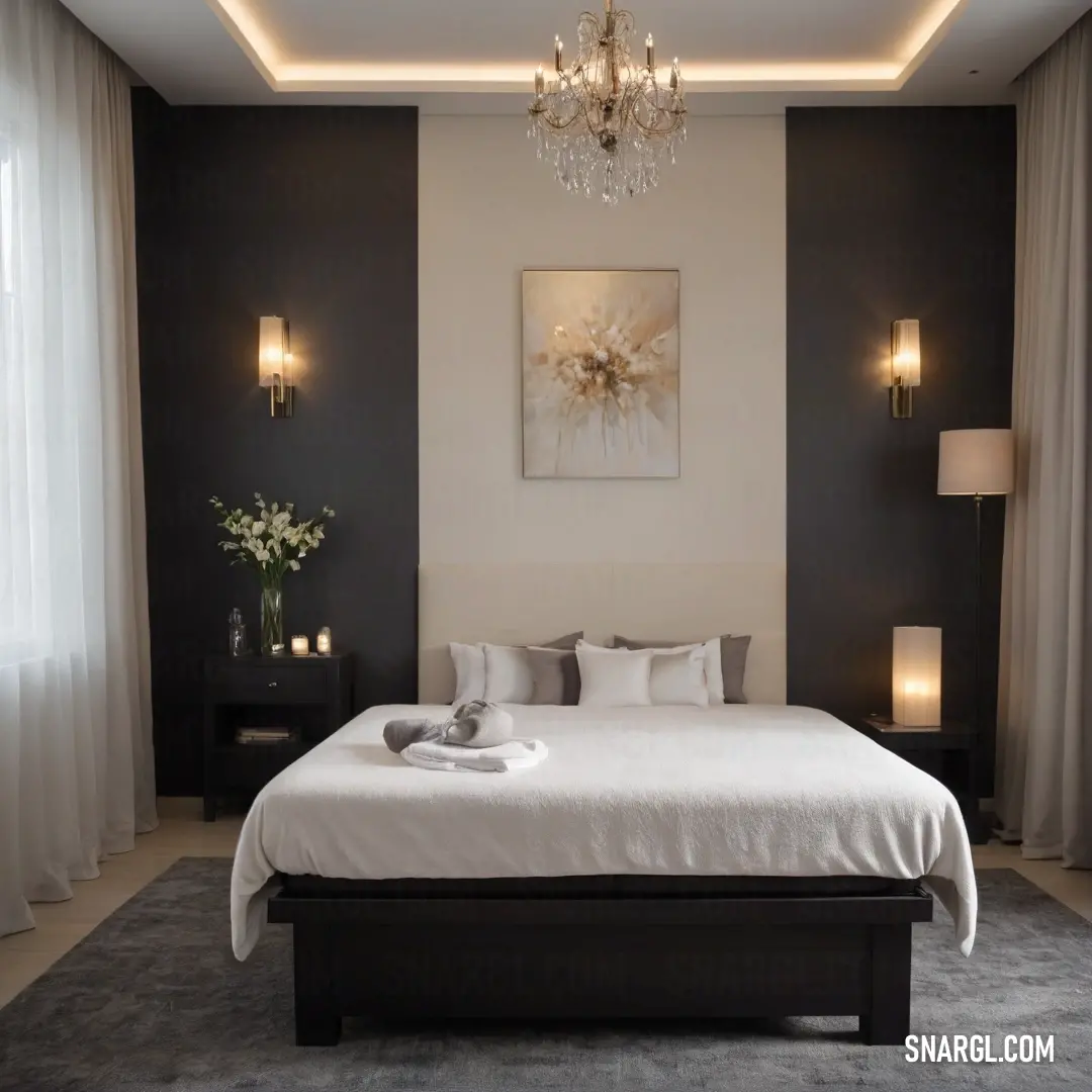 A spacious bedroom features a grand bed and a stunning chandelier that hangs elegantly from the ceiling, accompanied by artworks gracing the walls. The light, airy atmosphere creates a perfect blend of luxury and comfort, ideal for restful retreats.