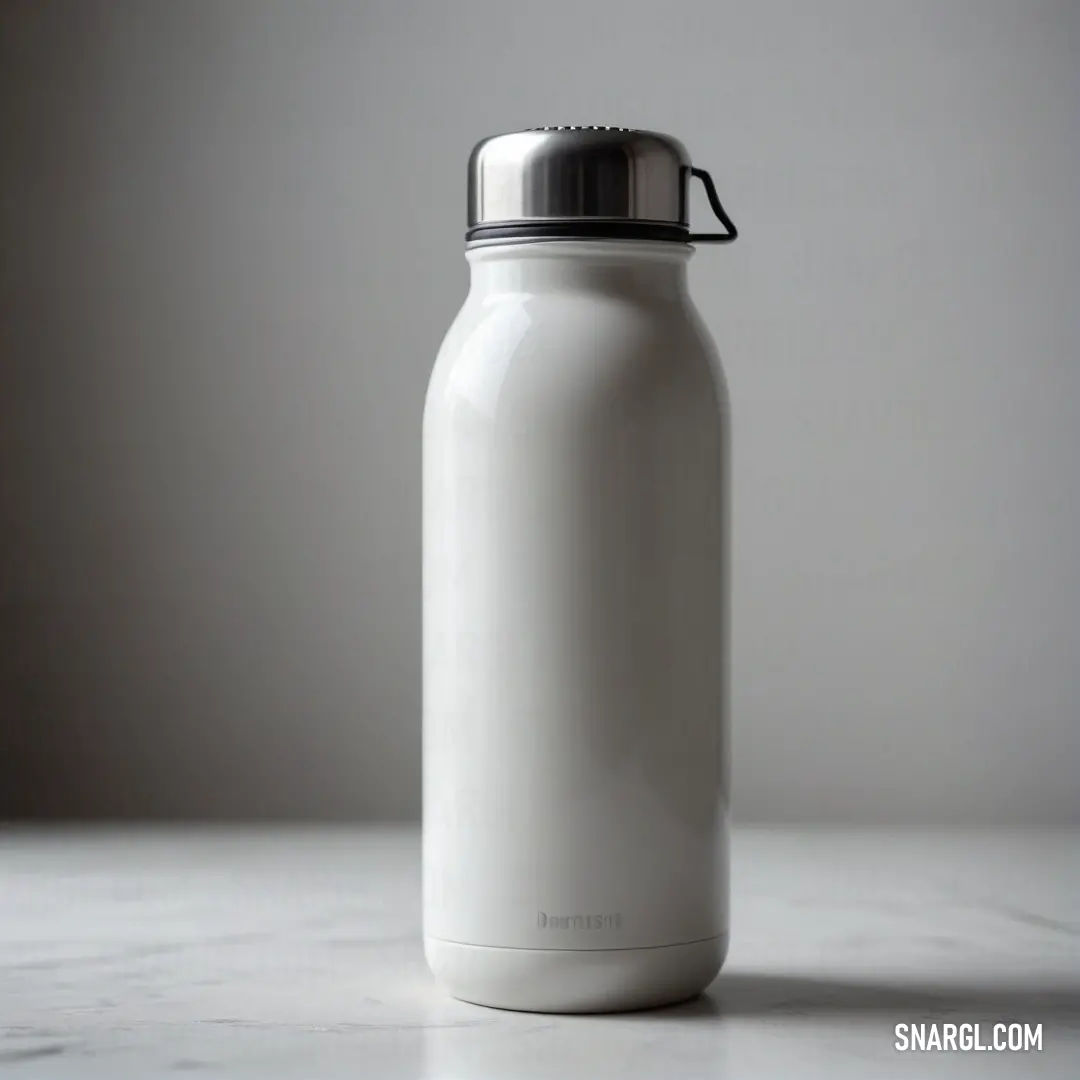 A white bottle elegantly sits atop a pristine white countertop, juxtaposed against a subtle gray wall. Its flawless design and vibrant color choice create a calm and inviting atmosphere, perfect for contemporary spaces.