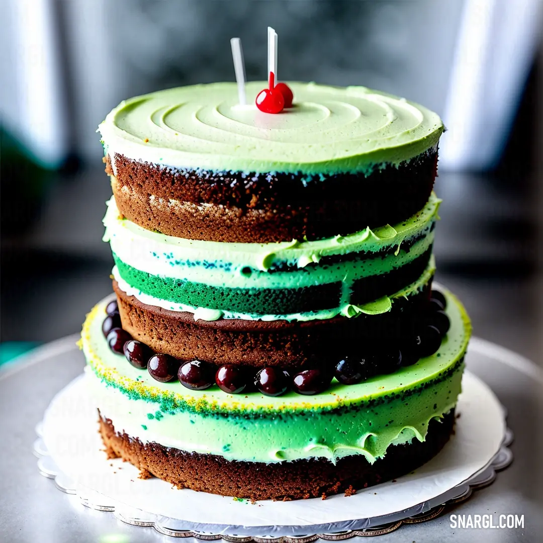 #008139 color example: Cake with green frosting and a cherry on top of it on a plate with a silver platter