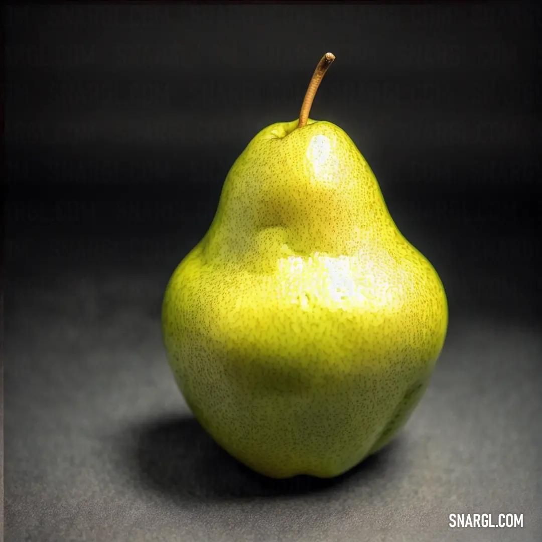 Pear on a table with a black background. Example of PANTONE 395 color.