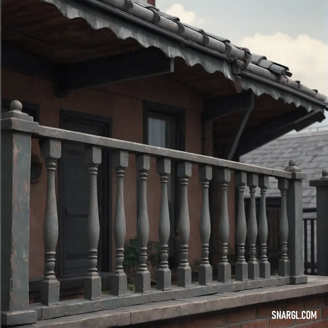 A curious cat lounges on a balcony, gazing towards a nearby building adorned with a clock. The brick wall behind it adds a rustic charm to the scene, with a hint of color seen in the surroundings.