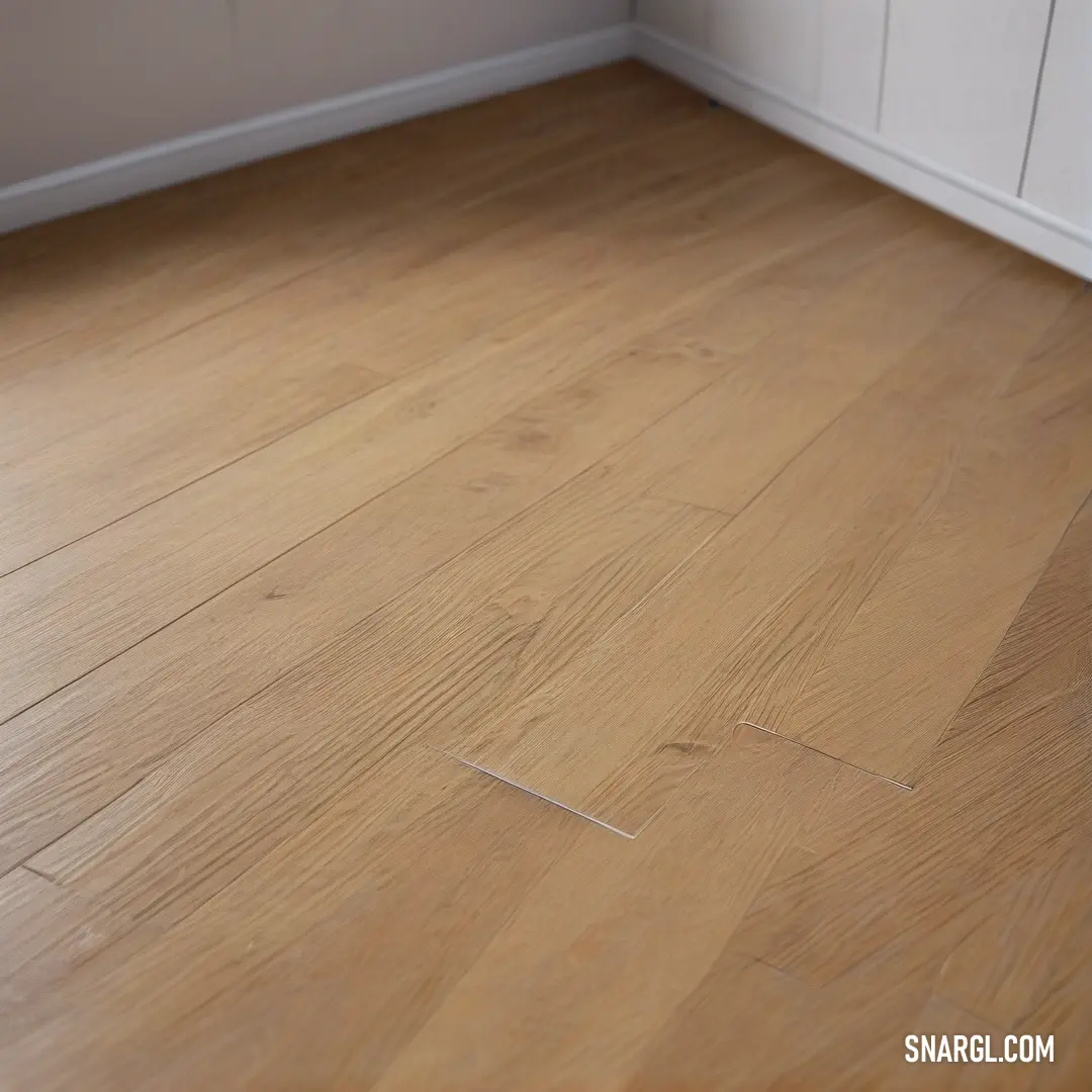 A wooden floor stretches beneath a white cabinet, with a simple white wall and door framing the scene. The soft color of the floor and furniture adds a sense of lightness and tranquility to the space.