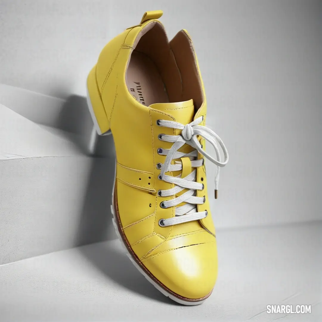 An appealing pair of yellow shoes with cute white laces rests on a flawless white surface, showcasing their bright color and playful design, inviting anyone to imagine the joy of stepping into them.