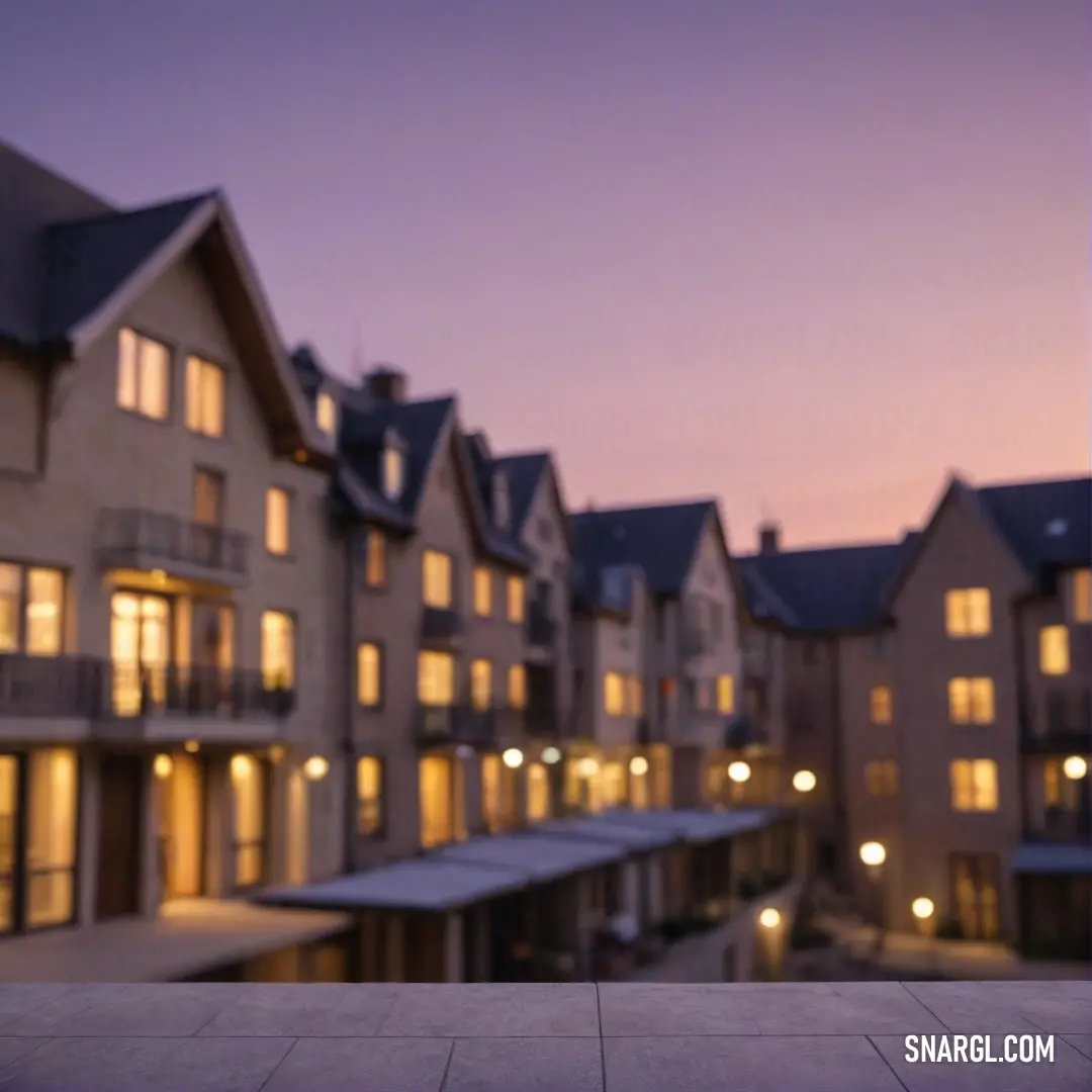 An impressive building at night, its many windows illuminated with warm light. The striking architecture creates a captivating scene, drawing attention to its unique design against the night sky.