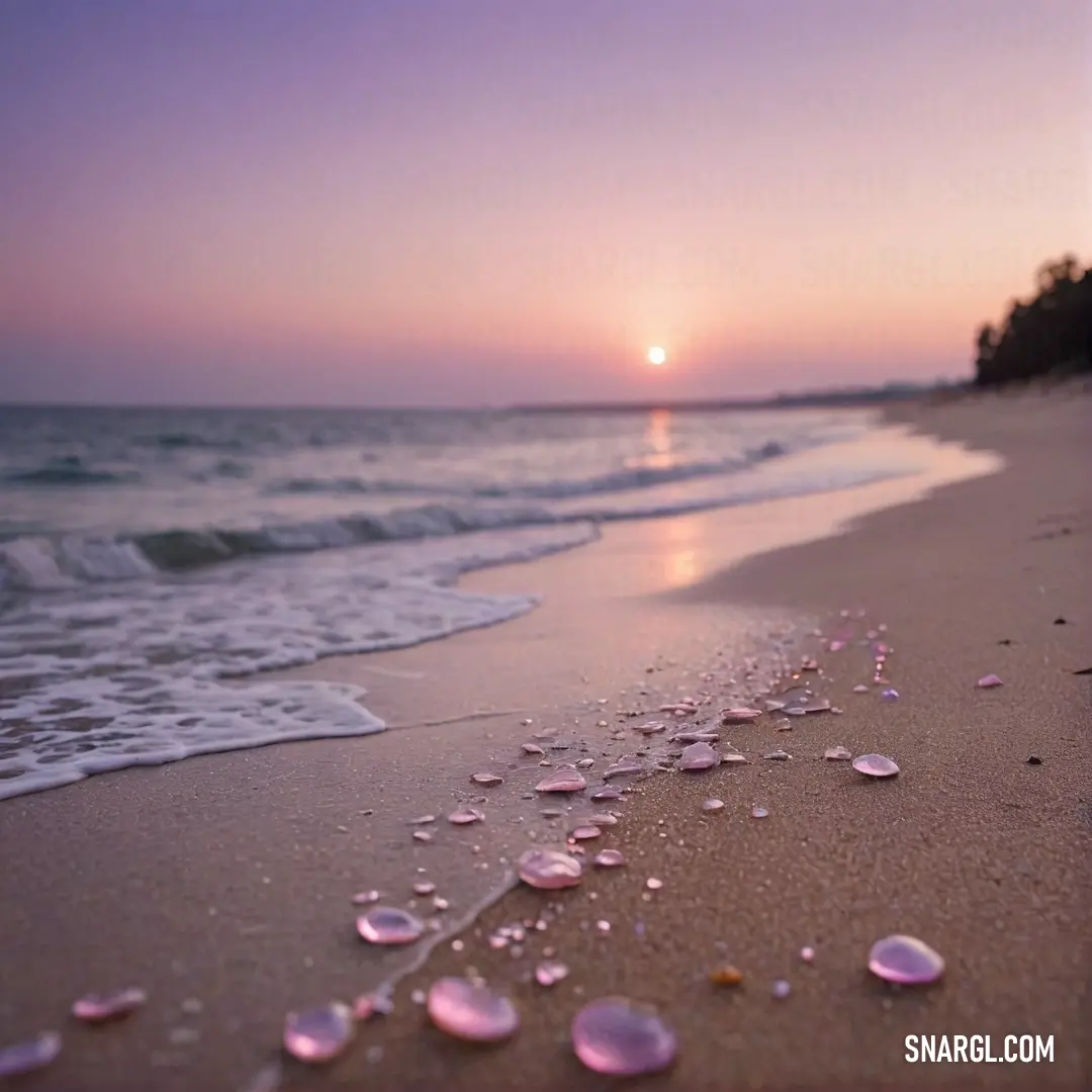 A picturesque beach at sunset, with soft sand and gentle water lapping at the shore, creates a mesmerizing scene where the sun sinks slowly beyond the horizon, painting the sky in warm hues.