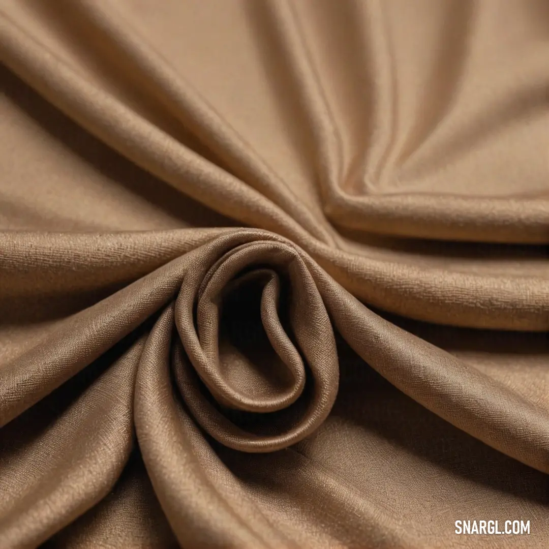 An inviting close-up presents a soft tan fabric flaunting a circular design at its center, beautifully nuanced in the warm tones of PANTONE 468, radiating comfort and style.