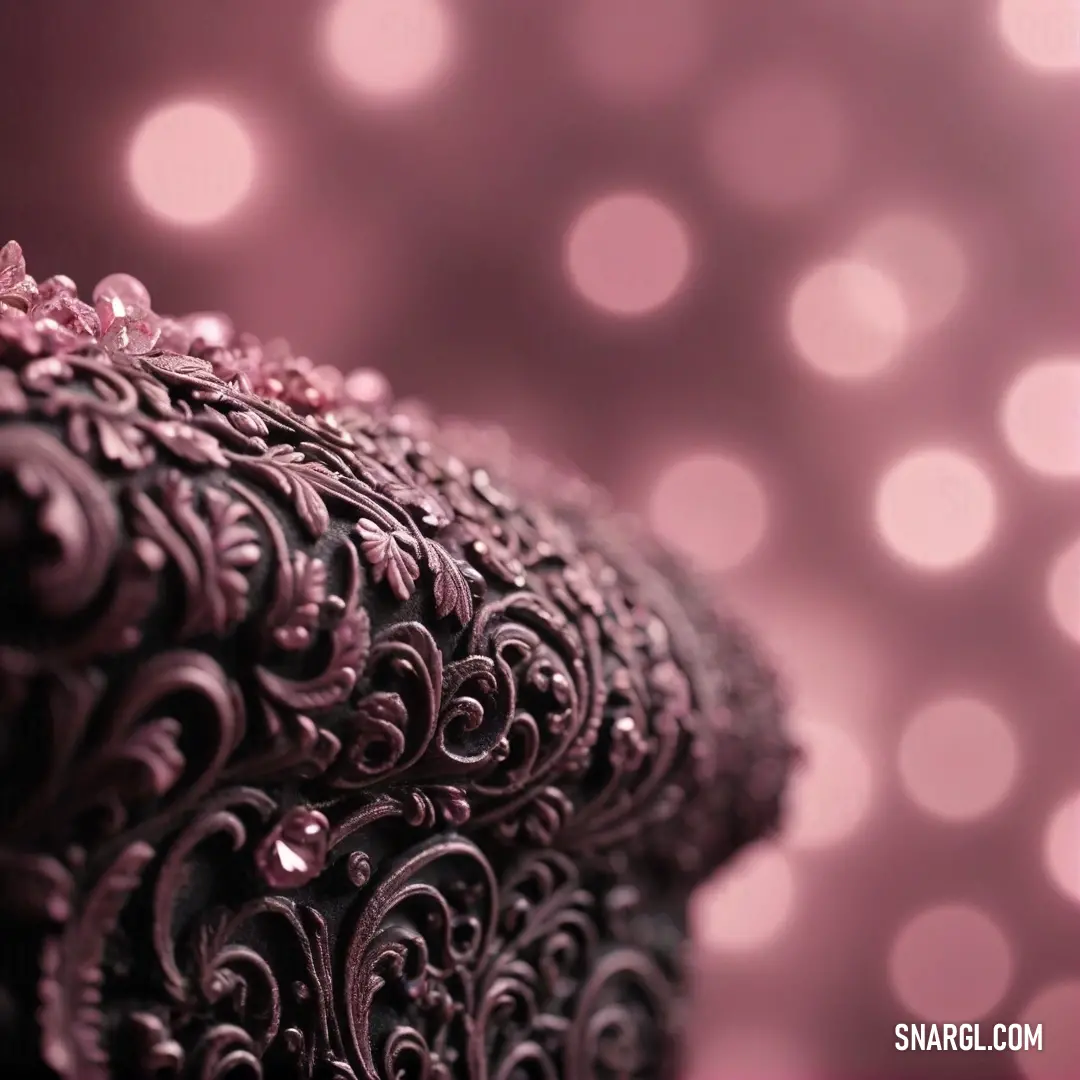 A detailed close-up of a striking purple and black dress adorned with intricate patterns, gracefully set against a dreamy blurred background, exemplifying the elegance of PANTONE 468.