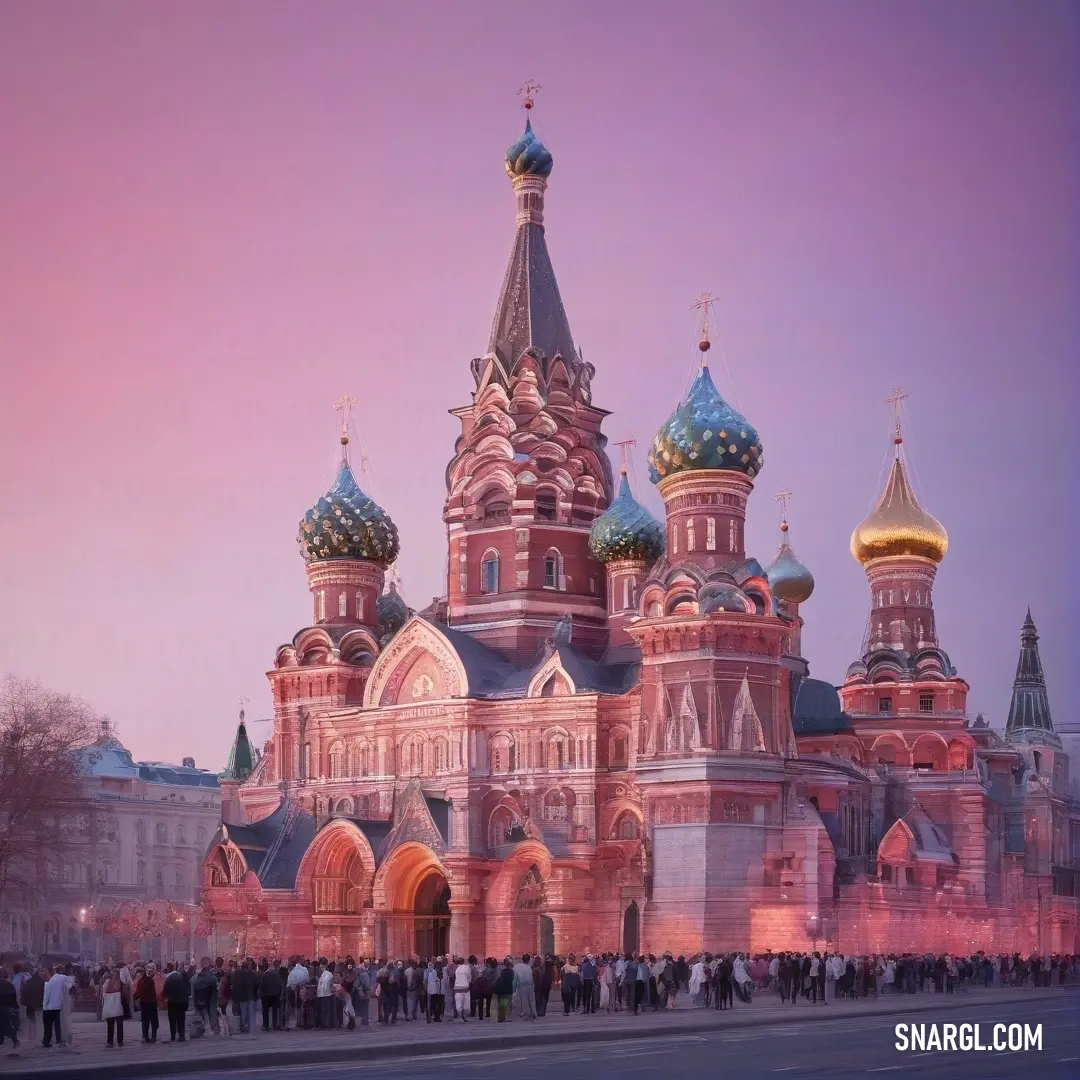 A striking building stands silhouetted against a dusky pink sky, where people gather, their silhouettes blending into a scene that radiates warmth and evening charm.