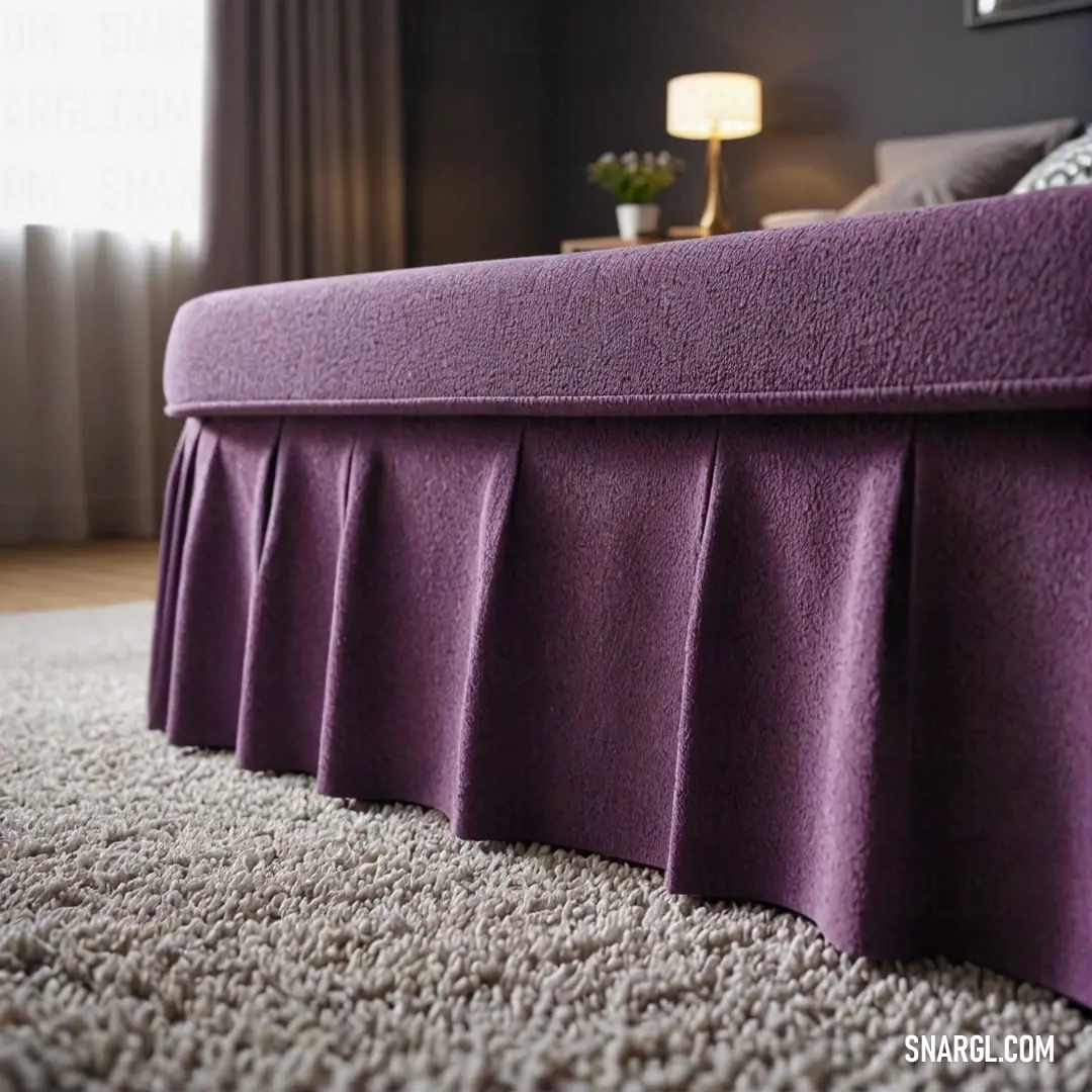 A beautifully arranged bed featuring a deep purple bed skirt draping elegantly over the headboard, enhancing the cozy ambiance of the room and showcasing the luxurious PANTONE 519 color palette.