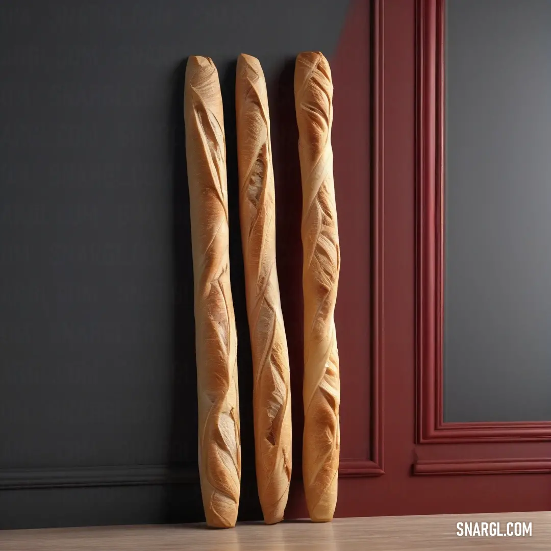 Two fresh bread loaves on a counter beside a door with a striking red frame. The warm, inviting color of the bread contrasts with the cool, vivid tones of the red door frame, making this CMYK 65,95,9,40 color palette come alive.