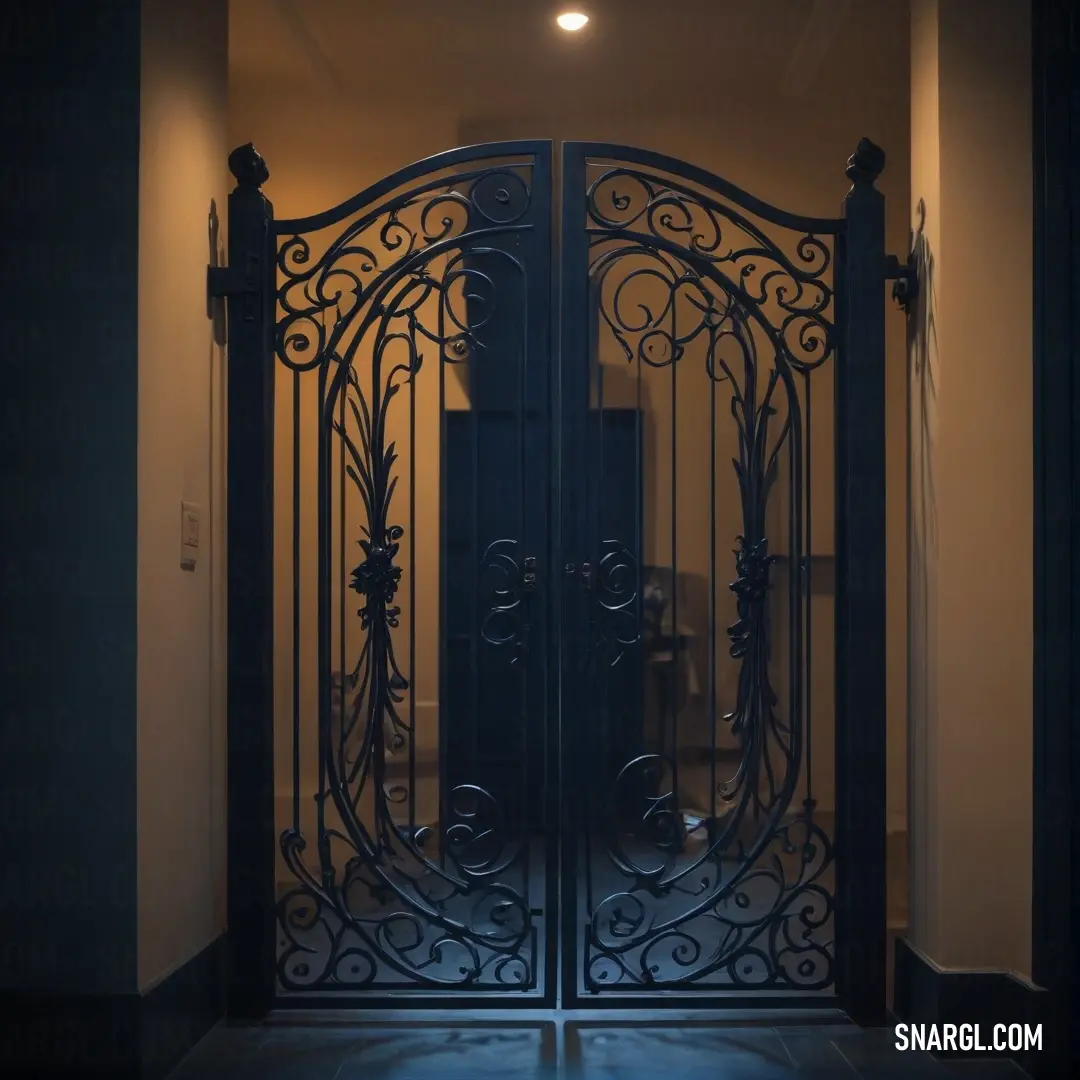 An imposing large metal gate stands tall with a warm light illuminating its intricate design, while a white toilet peeks out from behind, creating an unexpected yet captivating scene.