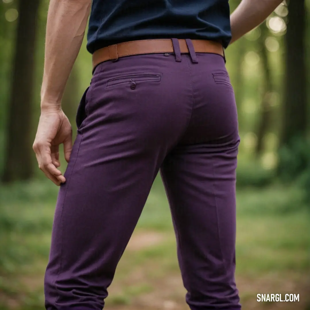 A figure clad in striking purple pants stands amidst a serene forest backdrop, surrounded by towering trees and dappled sunlight, illustrating the mesmerizing beauty of the RGB 94,45,93 color palette in nature.