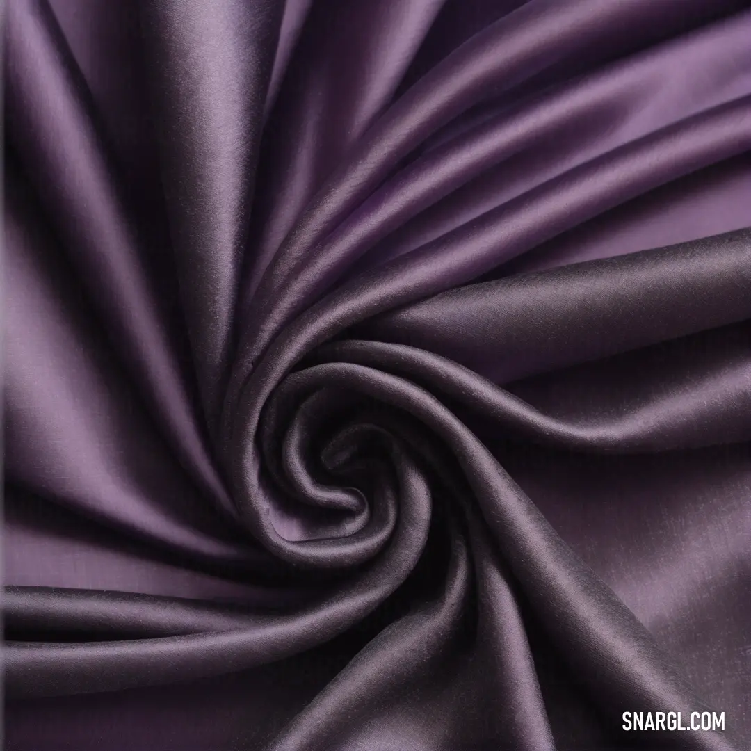 A vibrant purple fabric displays a bold, sweeping spiral design that draws the eye, contrasting dramatically with a pristine white background, showcasing the fabric's rich color palette with subtle variations.