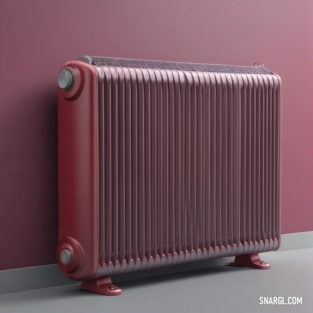 A red radiator leans against a soft pink wall, blending with the shades of the surrounding space. The warm tones of the radiator add vibrance to the room, which is enveloped in a soothing pink palette.