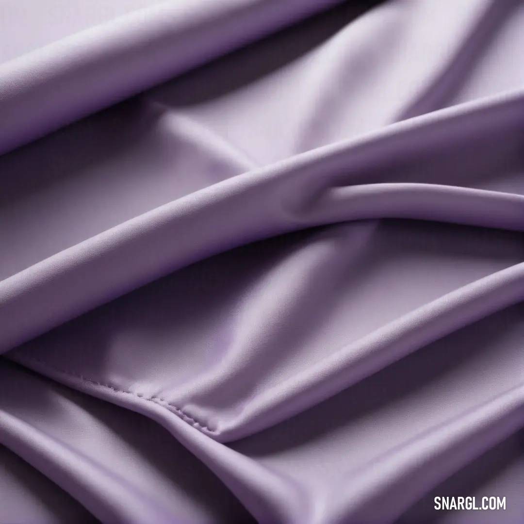 PANTONE 523 color. Close up of a purple fabric with a very soft feel to it's surface and folds in the middle