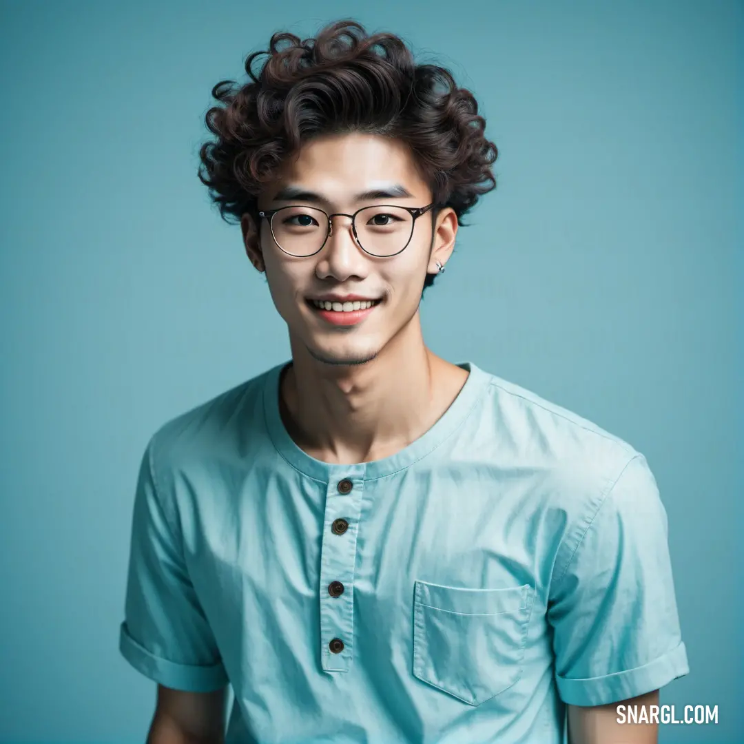 Man with glasses and a blue shirt on a blue background. Example of PANTONE 5493 color.