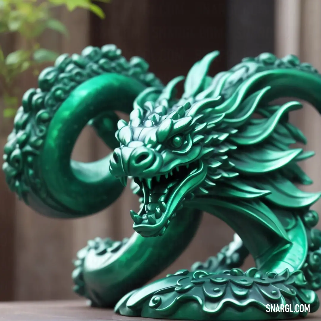 Green dragon statue on top of a table next to a planter and a wall in the background. Color CMYK 90,9,60,15.