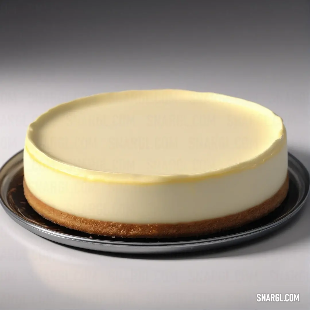 A fresh white cake resting elegantly on a metal plate with a silver rim, placed on a table against a pristine white background. Its delicate simplicity invites a closer look at its clean and inviting aesthetic.