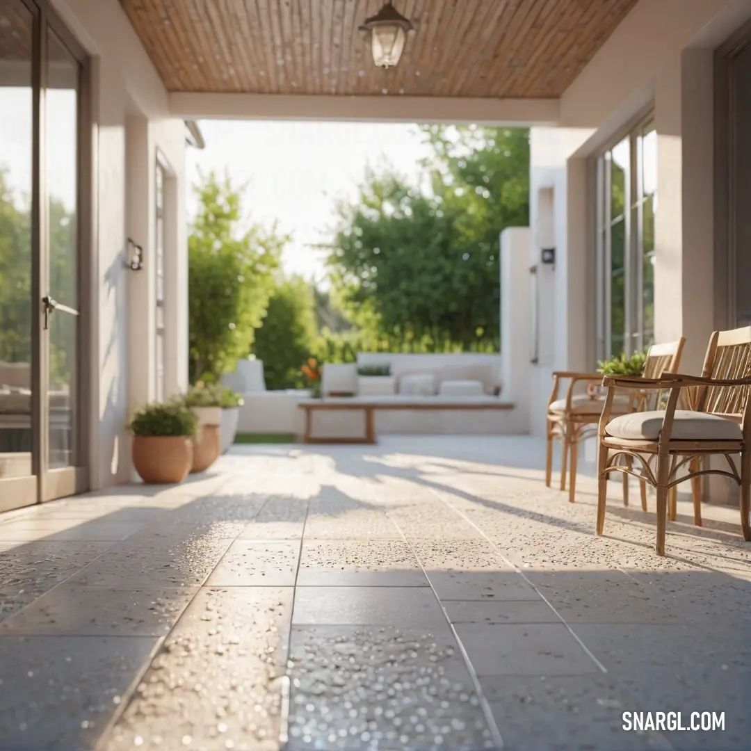 An inviting patio adorned with a table, chairs, and a potted plant, creating a cozy ambiance, while a comfortable couch resides in the background, displaying harmonious CMYK colors.