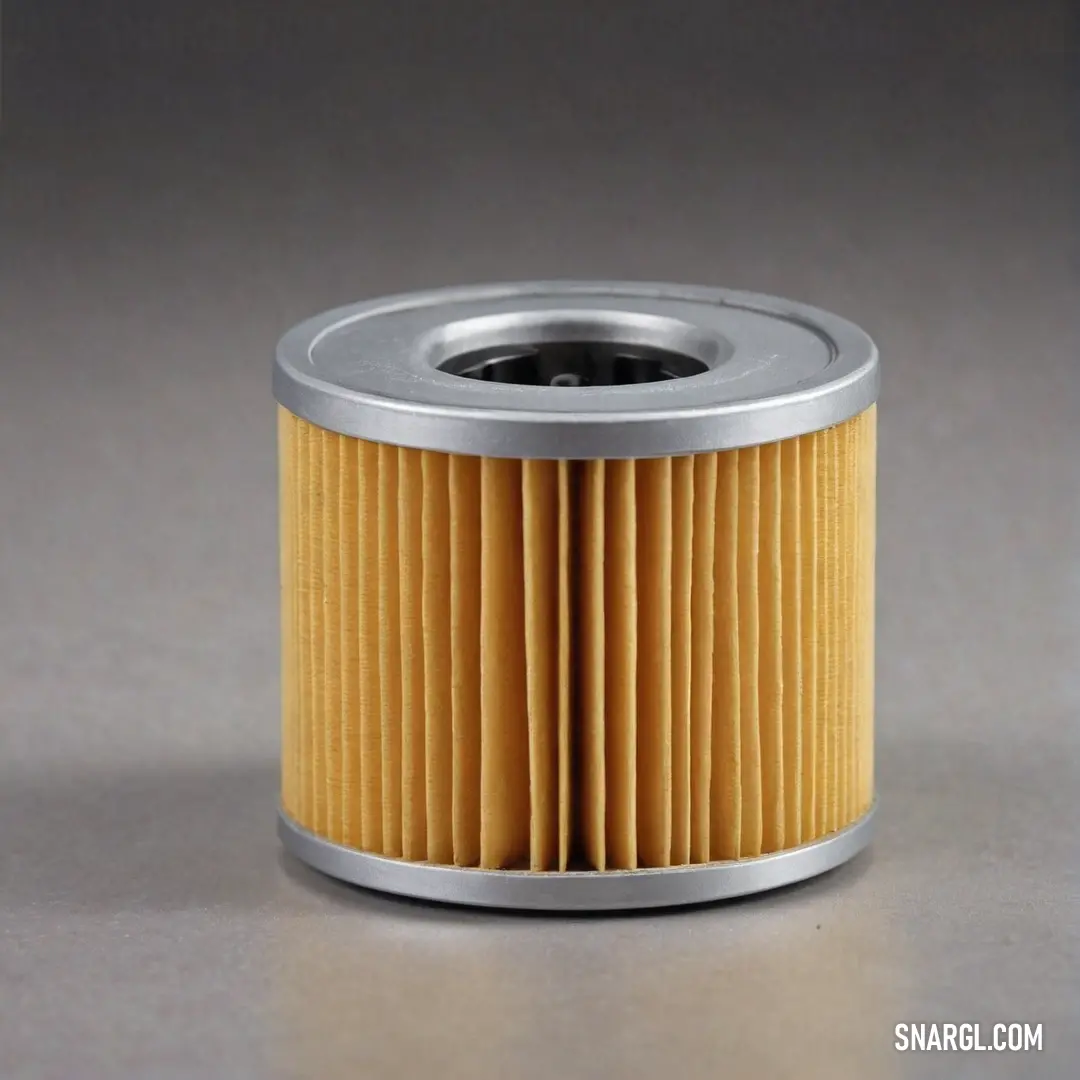 A close-up of a yellow air filter set against a smooth gray surface, with a metal ring around its perimeter and a black base. The combination of colors creates a modern, industrial aesthetic.