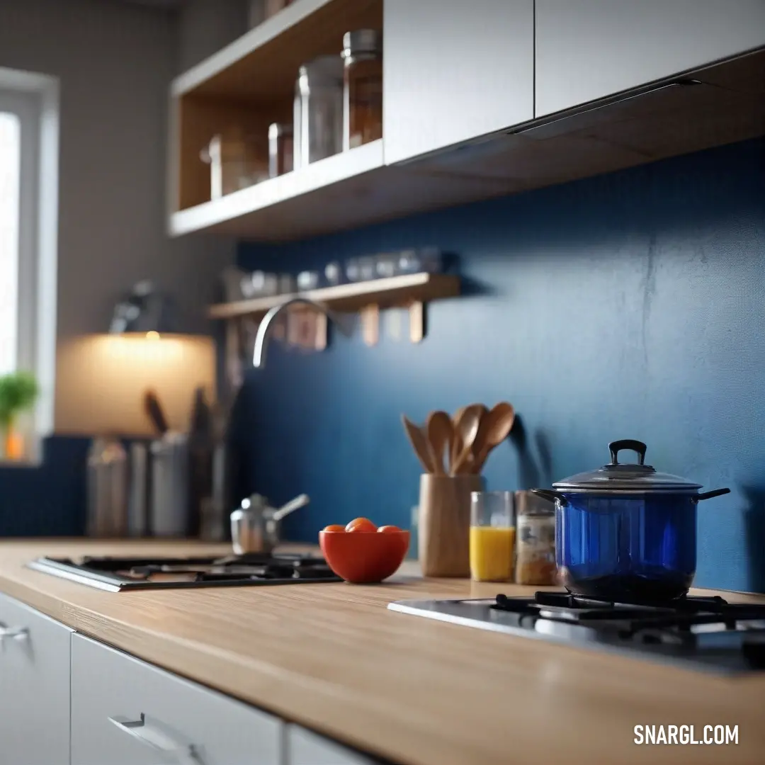 A kitchen counter with a stove, a pot simmering on top, and a light hanging above it creates a warm, inviting atmosphere. The soft glow from the light and the window adds to the cozy feeling of the space.