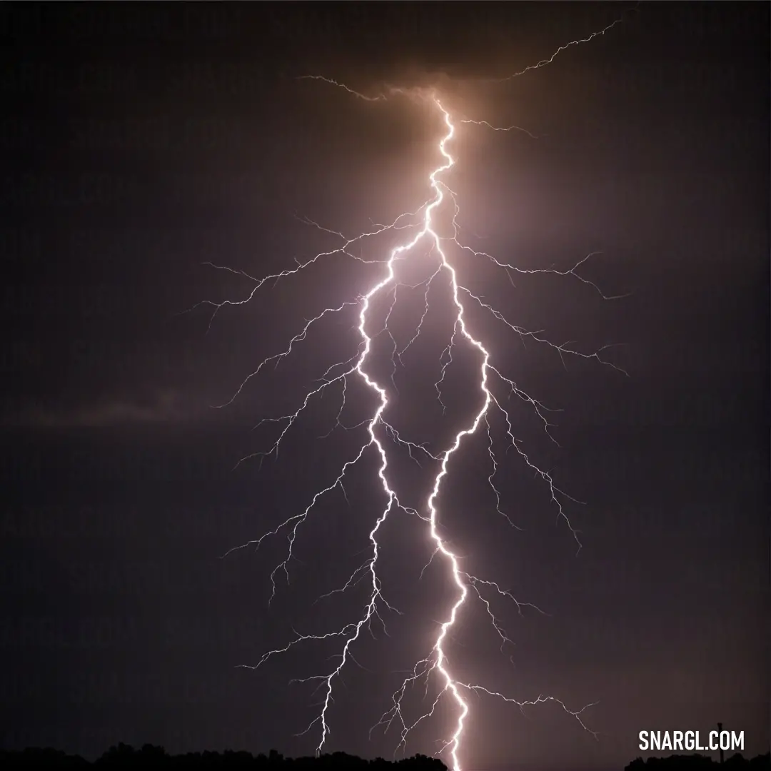 A powerful lightning bolt crashing to the earth in a darkened field, framed by silhouetted trees and a rustic fence, illustrating nature's raw intensity and beauty.