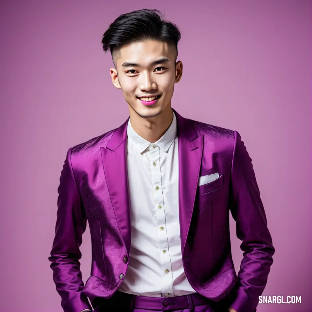 Man in a purple suit and white shirt smiling at the camera with his hands in his pockets