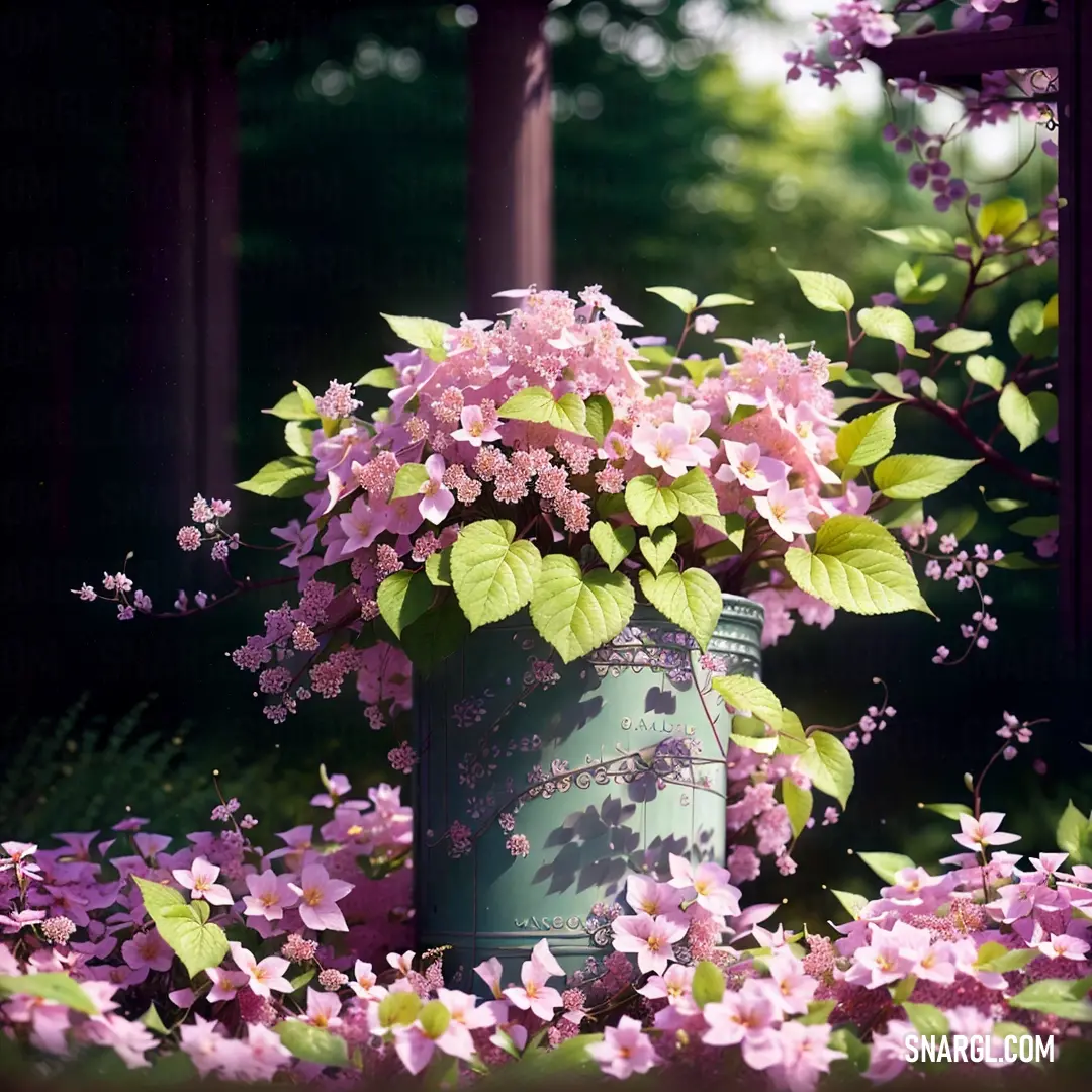 Large vase filled with lots of pink flowers next to a forest of trees and bushes with purple flowers. Example of CMYK 8,60,21,24 color.