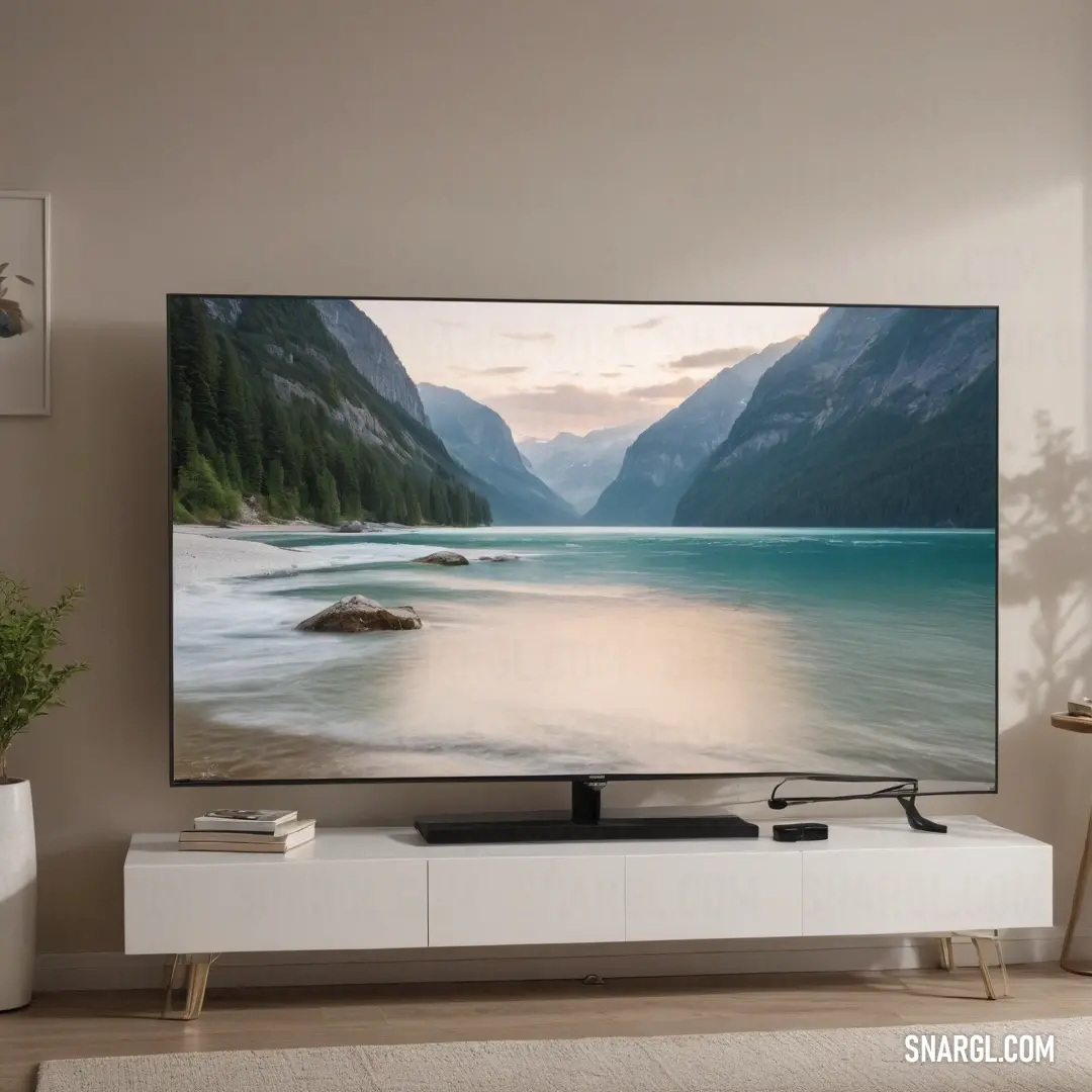 A modern living room showcasing a sleek flat-screen TV perched atop a stylish white entertainment center. A lush green plant adds a pop of color, creating a harmonious blend of relaxation and contemporary design in shades of CMYK 3,5,26,2.