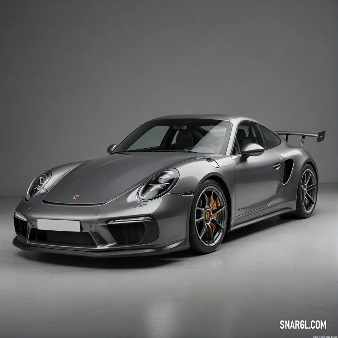 A sleek silver Porsche sports car rests gracefully in a garage, nestled against a muted gray background. The vehicle's polished curves and iconic styling reflect a legacy of excellence in automotive engineering and luxury performance.