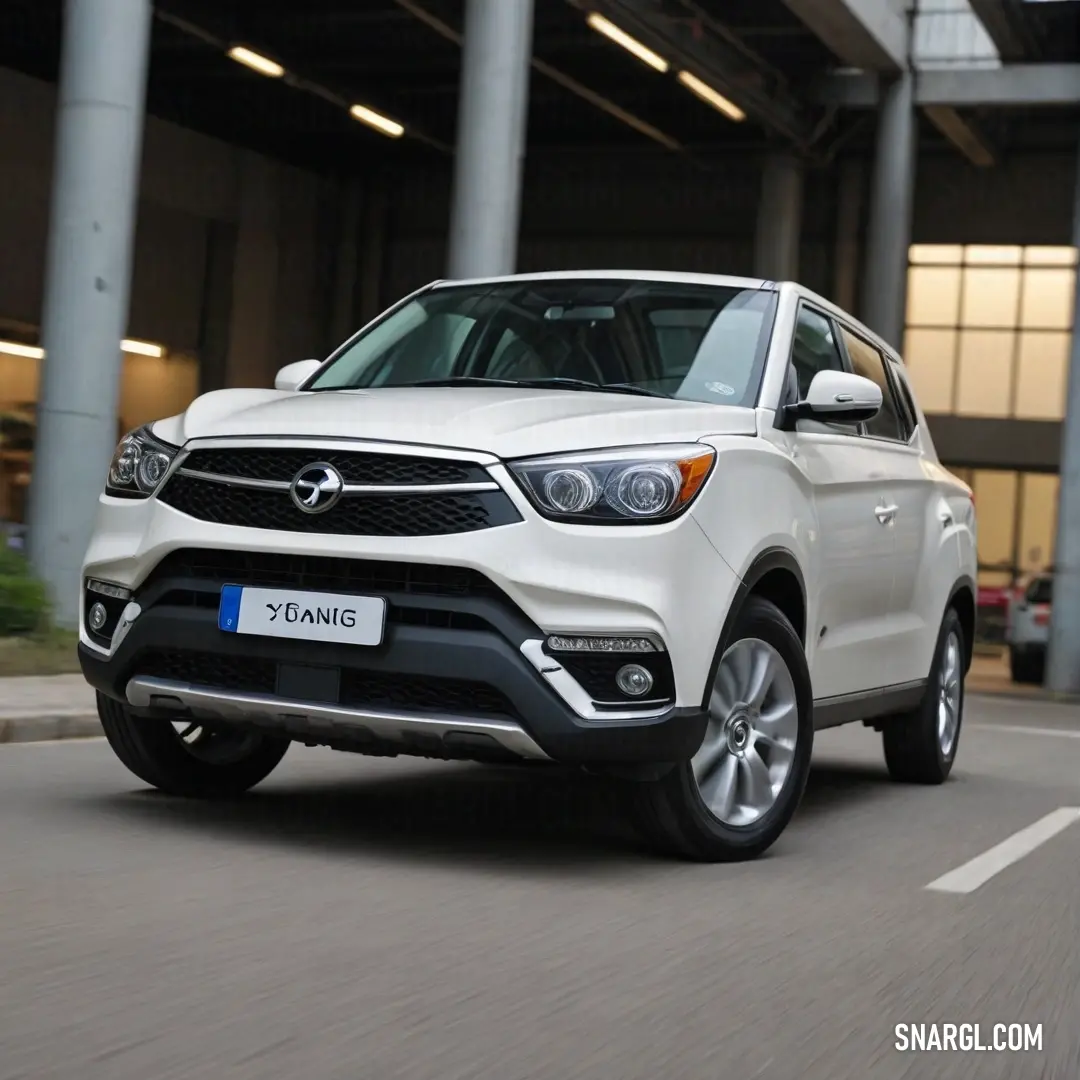 A sleek white SUV effortlessly navigates through a bustling street, its presence illuminated by the vibrant signage of a nearby building that reads 