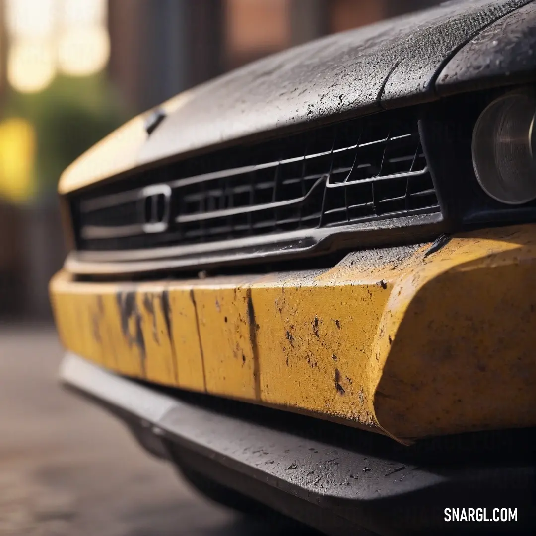 An engaging close-up of a car's front end featuring a distinct yellow bumper guard, its sleek lines and polished surface drawing attention. A backdrop blurs into soft hues, emphasizing the vehicle's design and character.