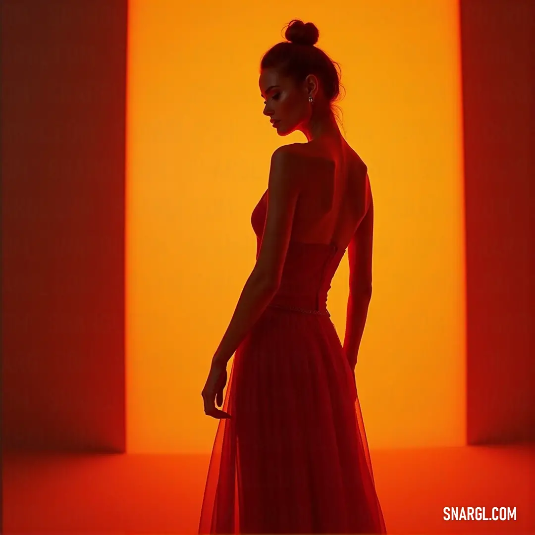 In a strikingly bright orange setting, a woman dons a beautiful red dress that stands out vibrantly. Her elegant posture and radiant smile juxtapose perfectly against the warm colors, creating an inviting scene enhanced by the RGB 214,157,42 hue.