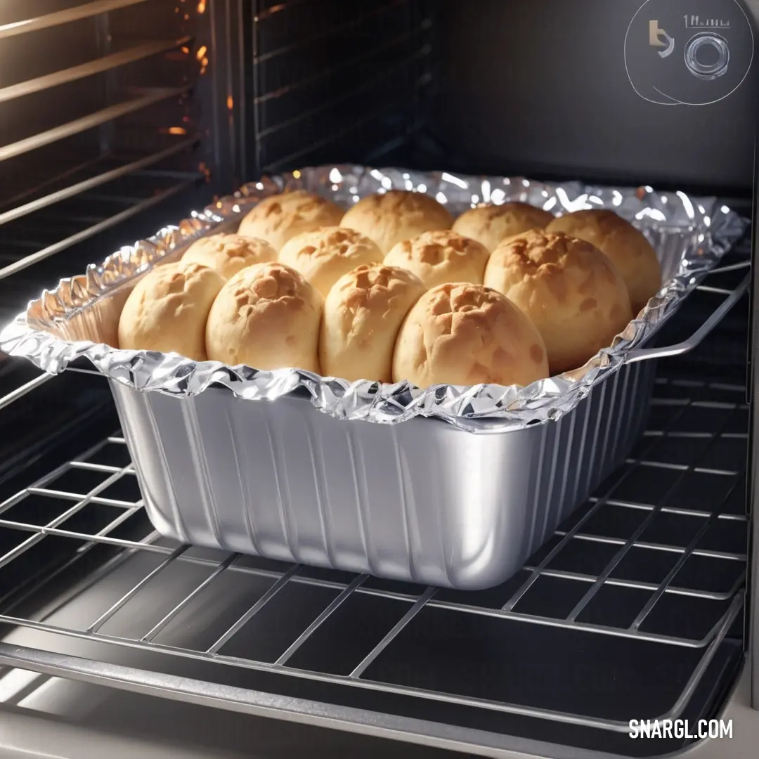 A baking pan filled with a golden-brown loaf of bread sits gracefully in an oven, complemented by an adjacent rack holding another baking pan. The warm light casts a delicious glow over the bread, hinting at the delight within, and showcasing the rich col