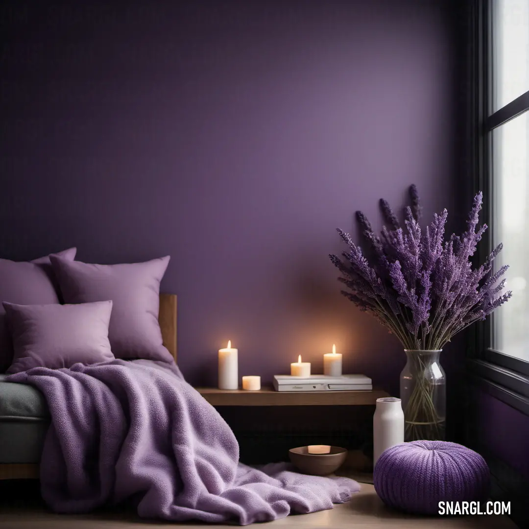 Bedroom with a purple wall and a bed with purple sheets and pillows and a vase with lavender flowers. Color RGB 96,80,98.