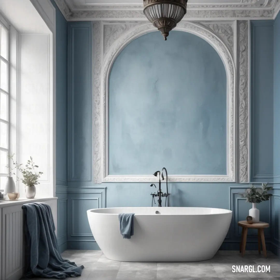 An elegantly designed bathroom showcasing a large bathtub against a calming blue wall, paired with a window featuring a stylish mirror, offering a peaceful retreat for relaxation.