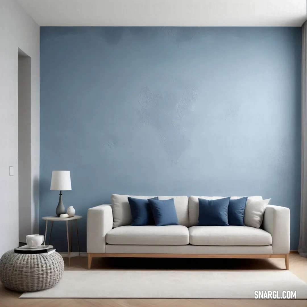 A cozy living room scene showcasing a comfortable couch and a sleek lamp in front of a striking blue wall, accompanied by a fluffy white rug, creating a perfect space for relaxation.