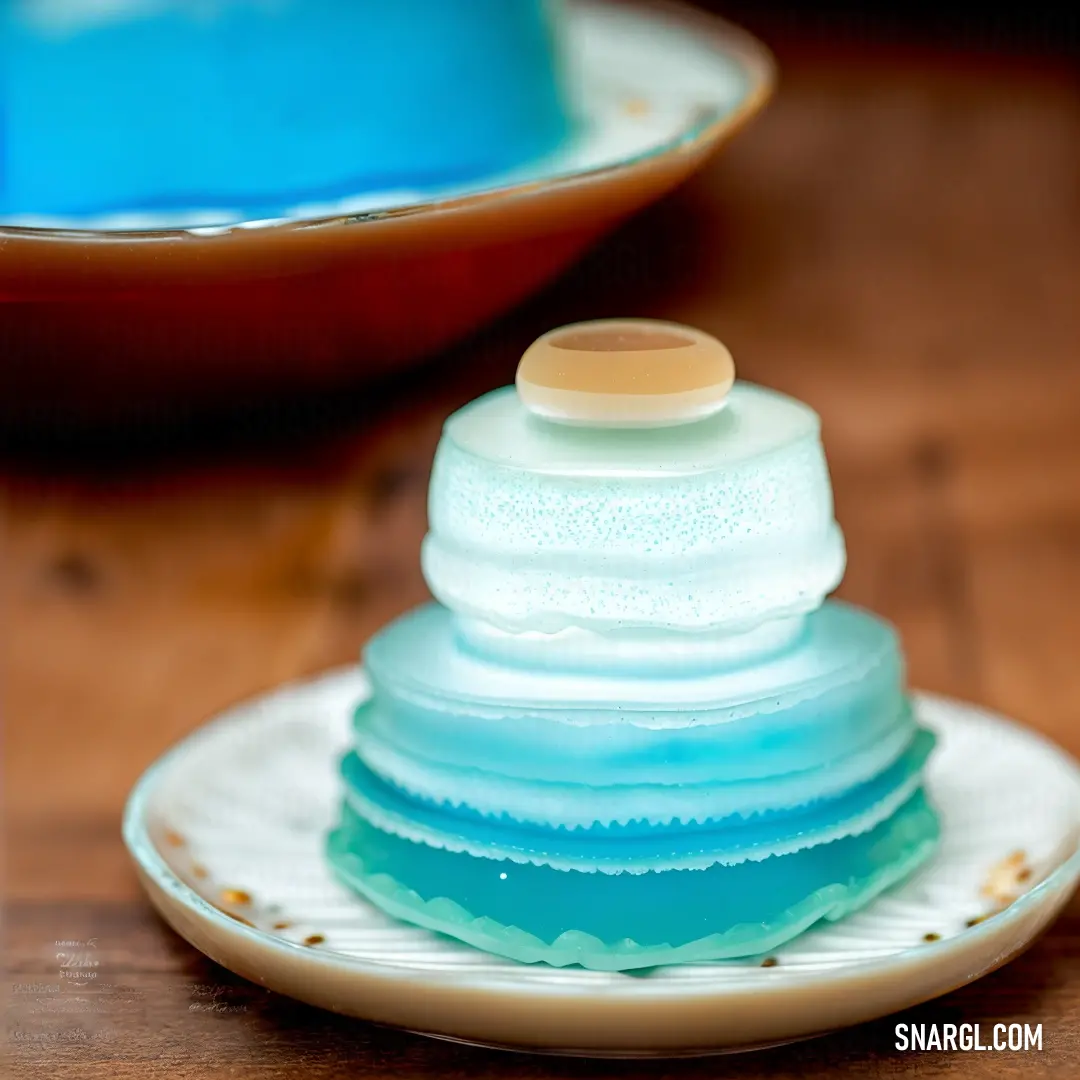 PANTONE 7710 color. Stack of blue and white glass on top of a plate on a table next to a bowl
