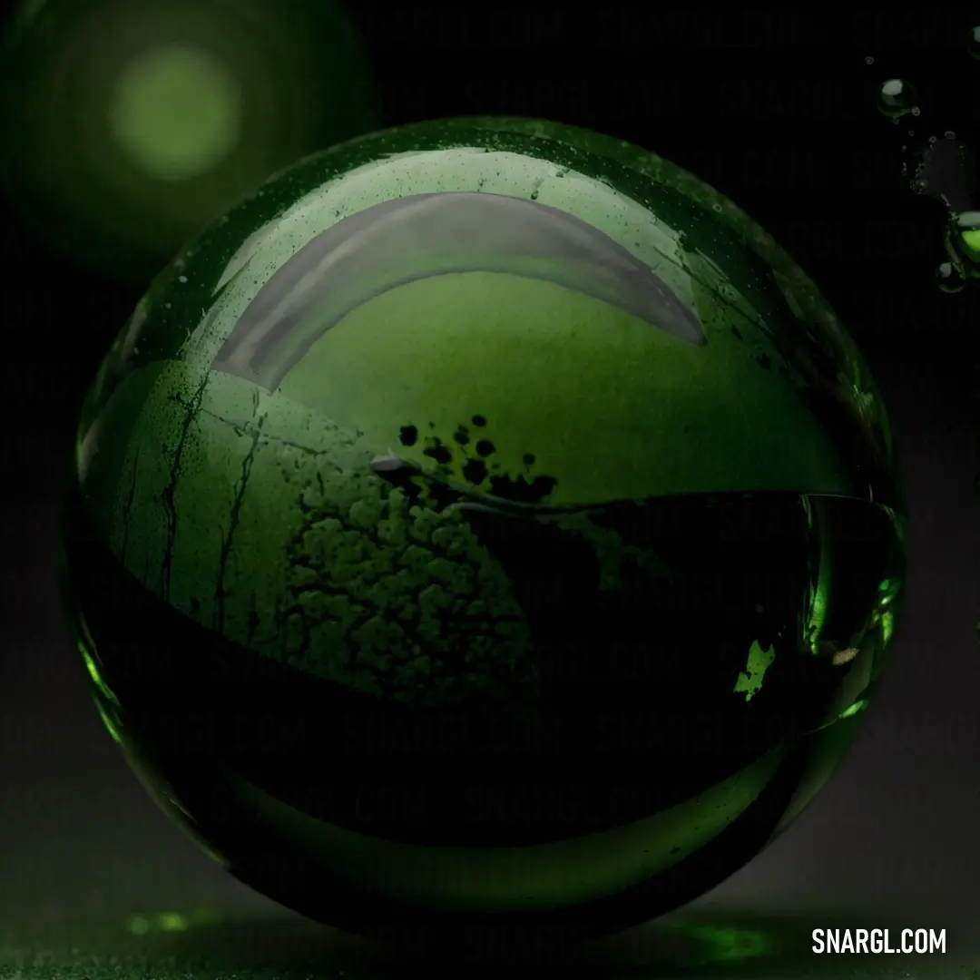 Green glass ball with a black background. Color #438A34.