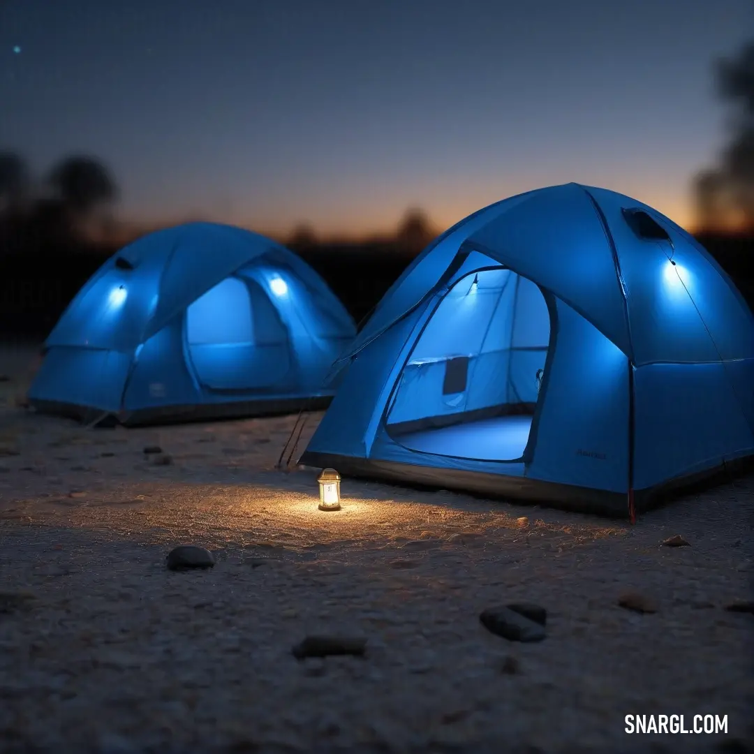 A serene nighttime scene featuring two glowing blue tents, casting soft reflections on the ground with flickering candlelight nestled between them, creating a tranquil ambiance under a starlit sky.