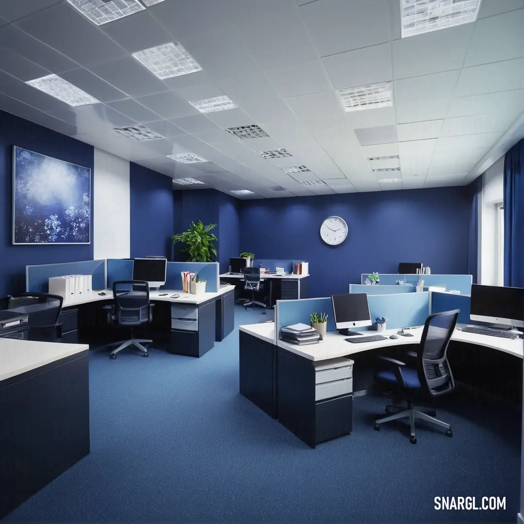 Room with a desk and chairs and a clock on the wall above it and a blue carpeted floor. Color PANTONE Reflex Blue.