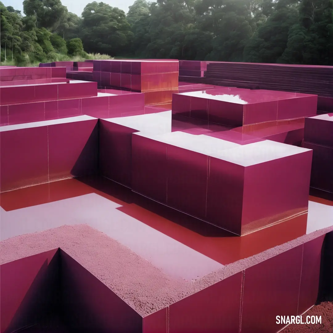 A grand pink structure, filled with colorful pink blocks at its center, framed by lush green trees. This captivating scene radiates the vibrant energy of PANTONE Rhodamine Red against natural surroundings.