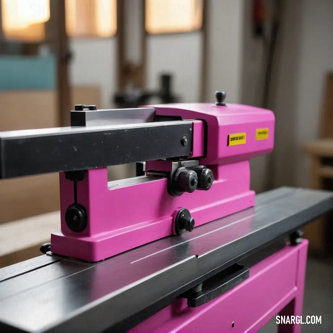 A delightful pink machine rests on a sleek table within a sunlit room, surrounded by large windows that allow the fresh light to pour in. The cheerful color and modern design beckon curiosity, inspiring thoughts of innovation and creativity in any workspa