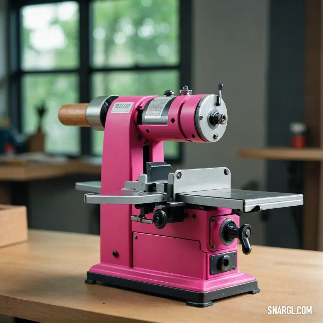 A striking pink machine sits prominently on a rustic wooden table, vividly contrasting with its natural surroundings. The machine's vibrant color is reminiscent of the PANTONE Rhodamine Red, adding a playful energy to the scene.