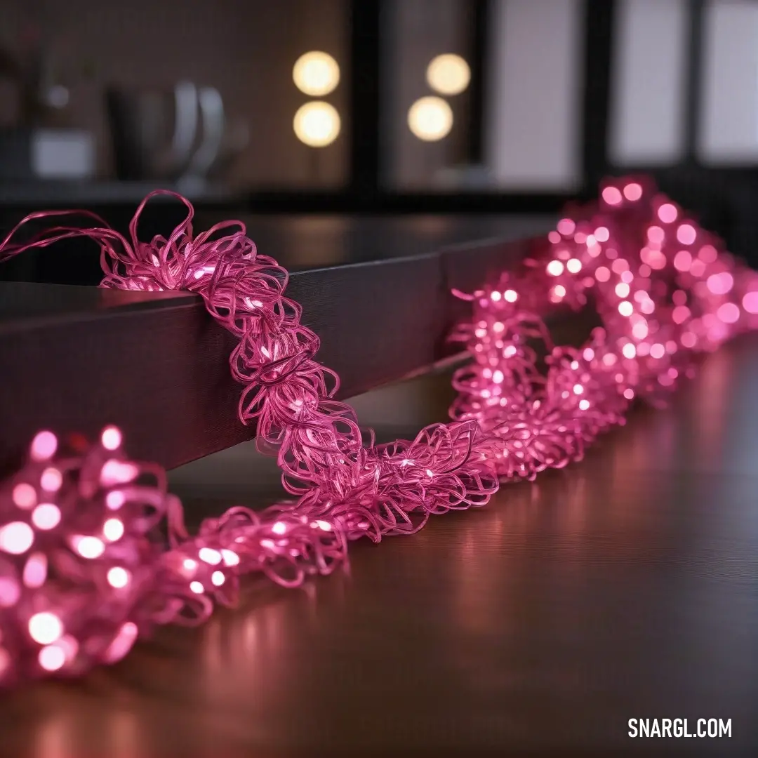 A delightful display of pink string lights playfully draped over a table, complementing a serene room bathed in natural light from the window. The cheerful hue adds a touch of warmth to the inviting atmosphere.