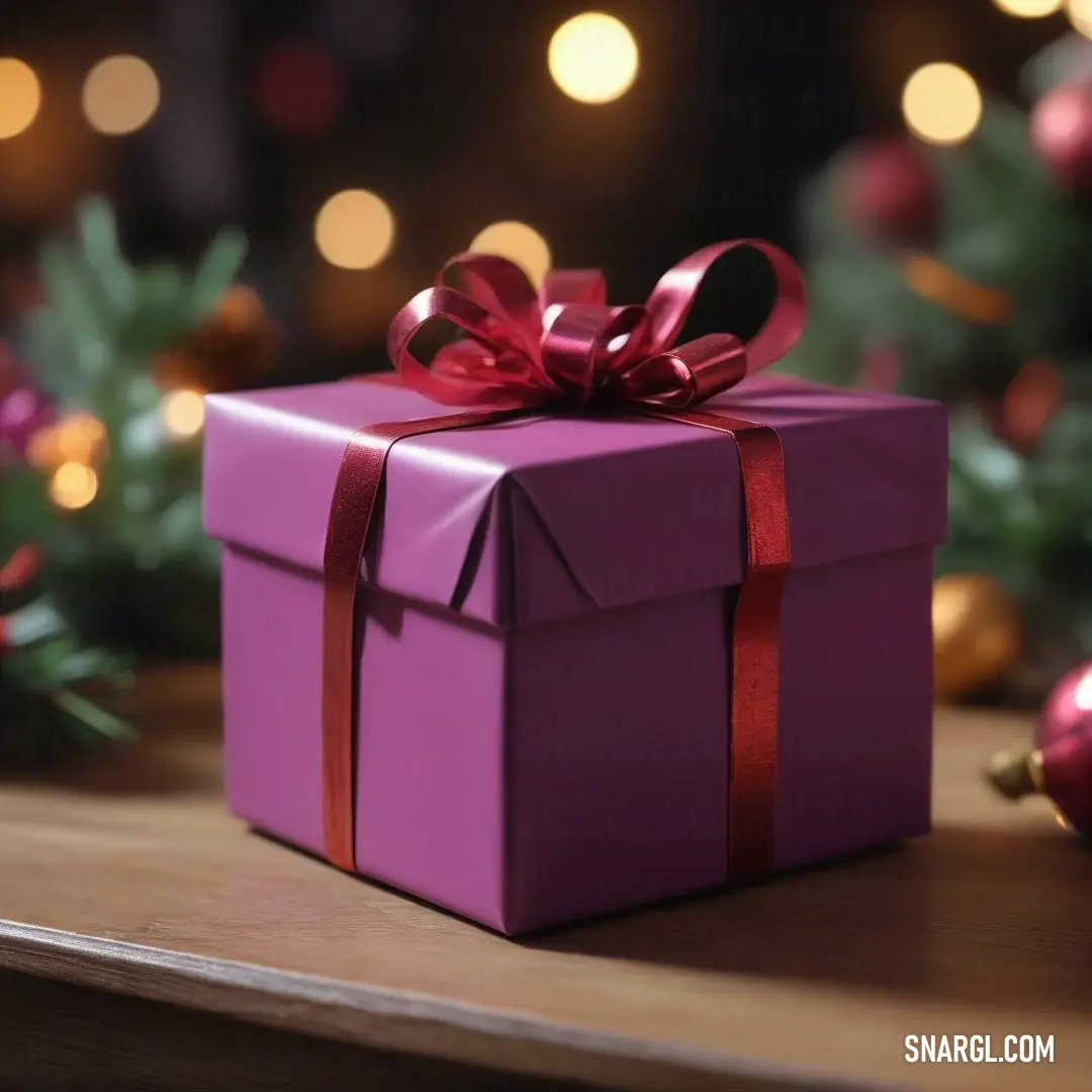 A beautifully wrapped purple gift box with a striking red ribbon and bow sits elegantly on a table surrounded by festive Christmas decorations, evoking the excitement and warmth of the holiday season.