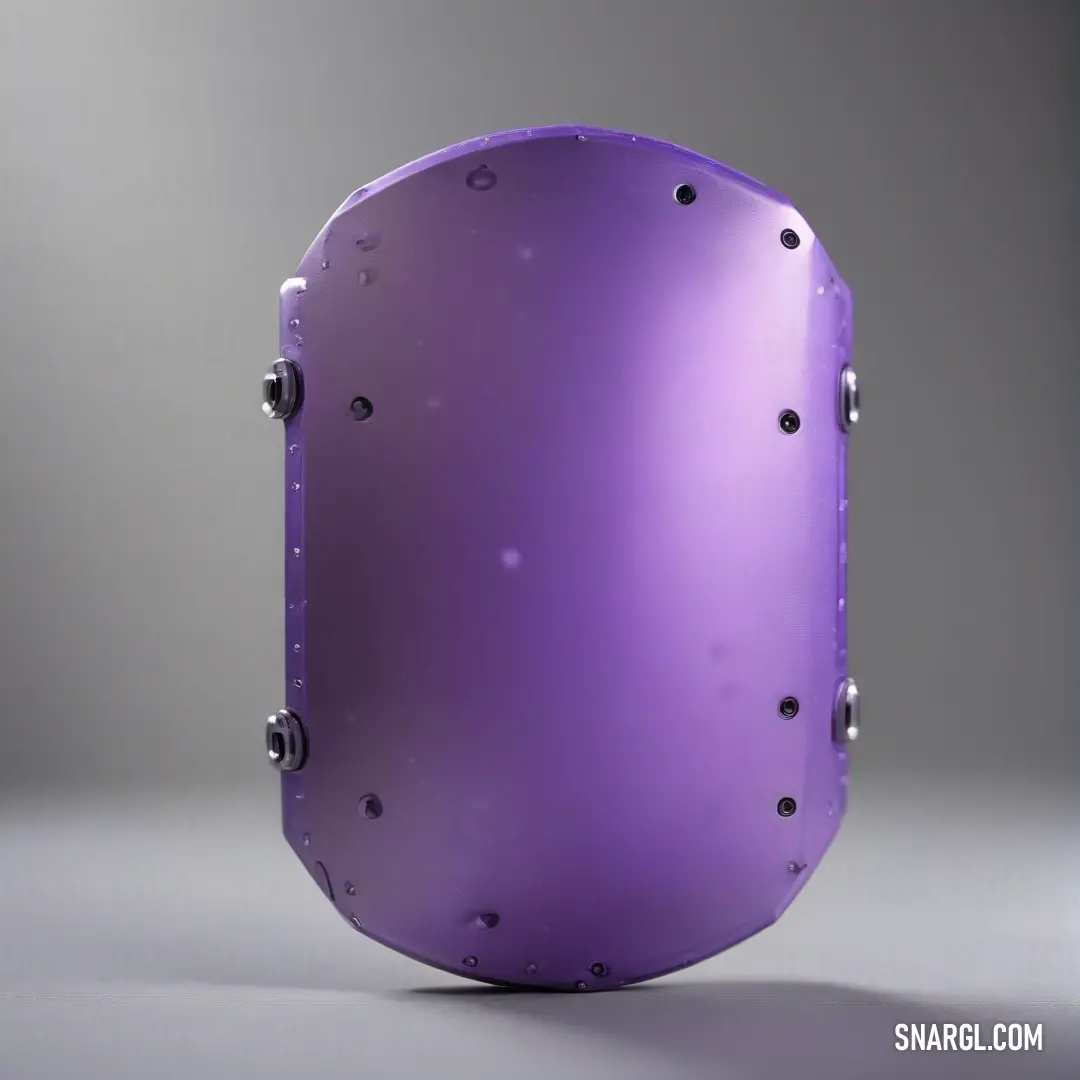 A unique purple object, featuring distinct holes and rivets, stands out against a clean gray backdrop, showcasing its intricate design and adding an element of curiosity to this industrial aesthetic.