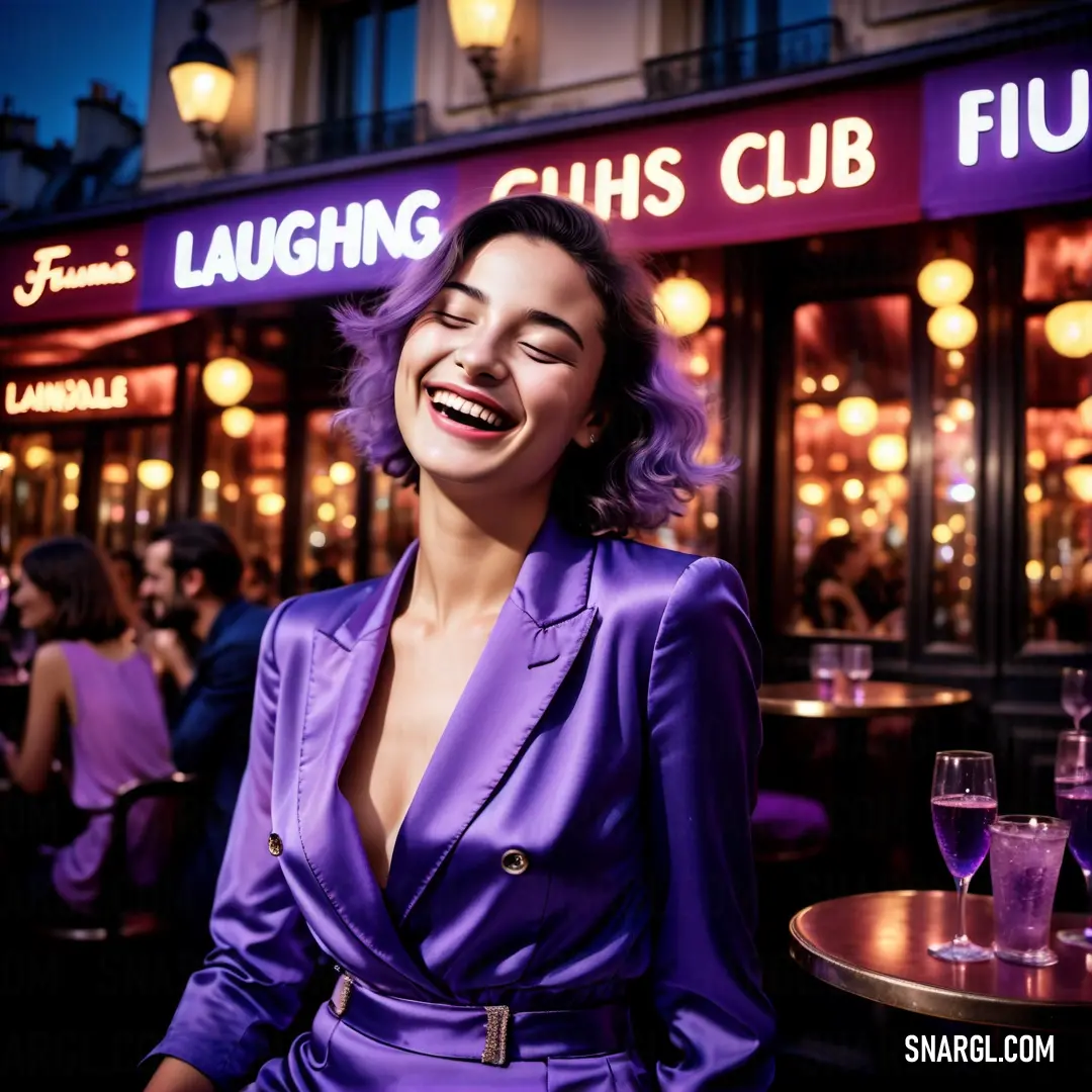 Woman in a purple suit at a table outside a restaurant smiling