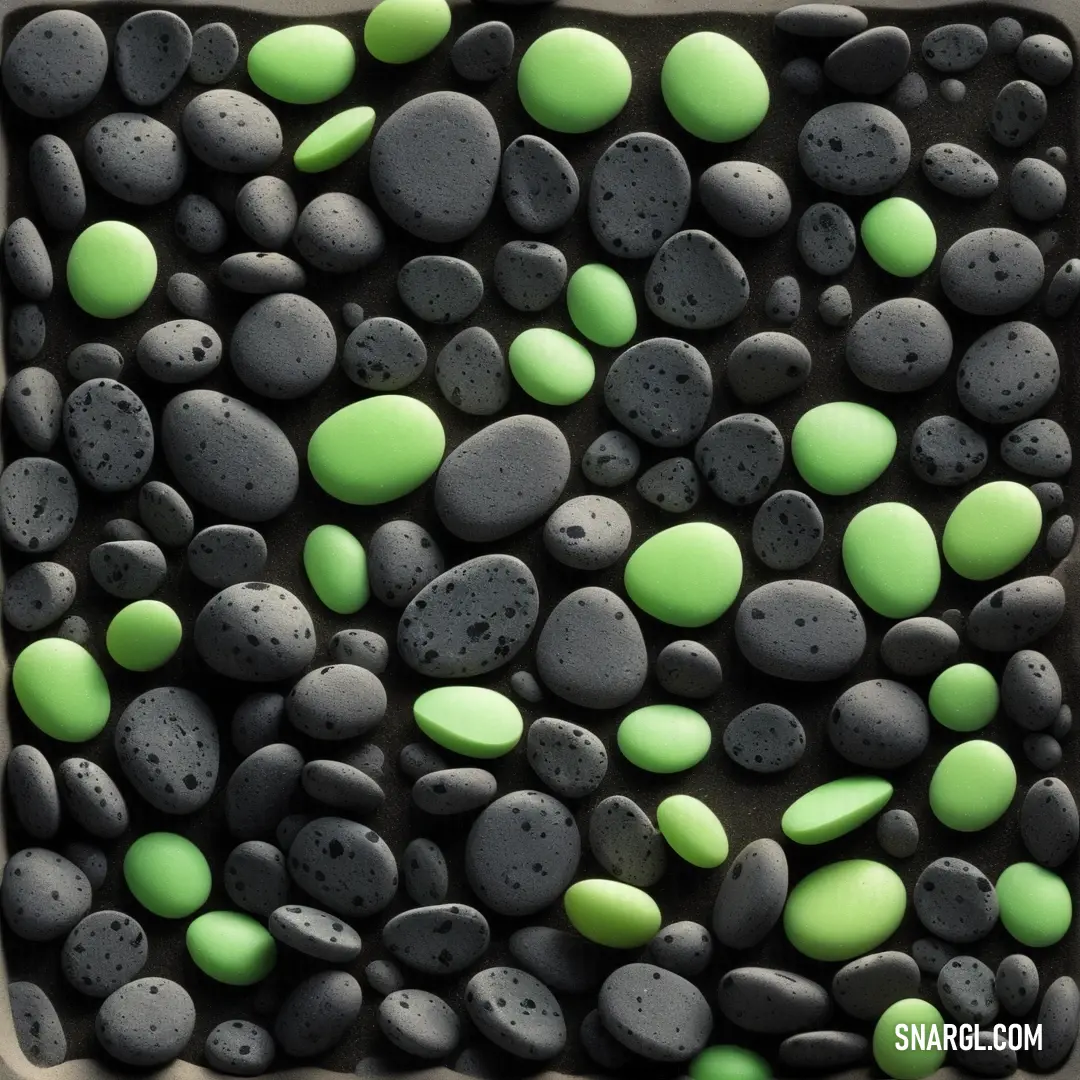 Pastel green color example: Square tray with green and black rocks on it and a white background